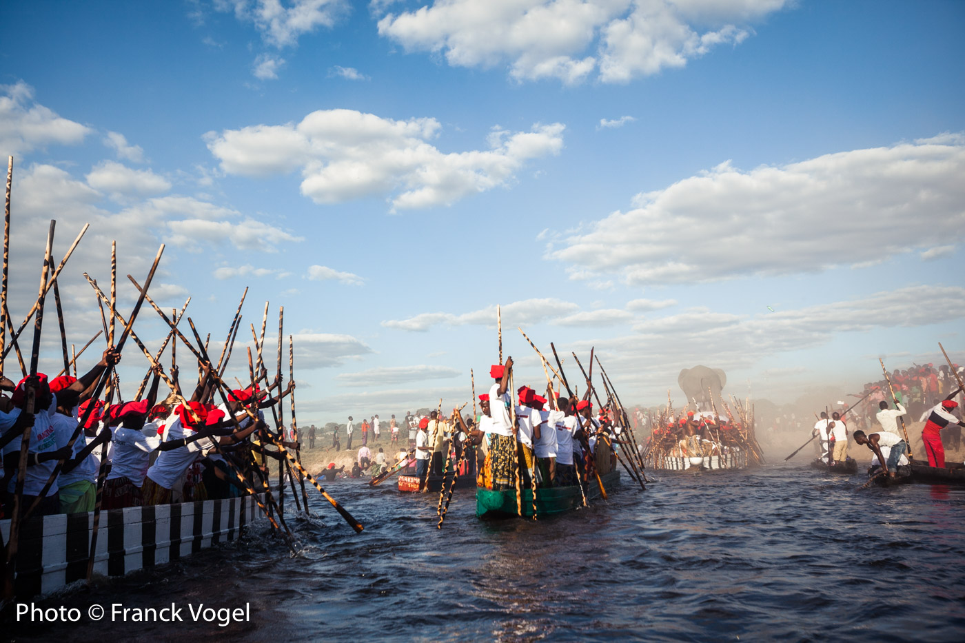 <p>Arrival at Limulunga, Barotseland, Zambia – The Barotseland and the amazing plains flooded by the Zambezi River in Western Zambia. In 2018, Lubosi Imwiko II, the King of the Barotse – also known as Lozi – has postponed the famous Kuomboka, the migration of the kingdom to dry land because for private reasons. It’s the first time it happened. April 28 he moved from Lealui (summer palace) to Limulunga (winter palace – April to June) using his Royal Barge topped with a 2m high elephant and propelled by 120 paddlers wearing leopard skins. During the 7h and 34km to reach the winter palace through the flooded plains, the drummers from the royal barge gives the rythm to all boats following, including the Queen’s barge (she passed away so her sisters and daughters are on it), the Ngambela (King’s prime minister), the royal Witchdoctor cannoe protecting the king and the royal barge with smoke and prayers, the cannoes with the gardians of former kings’ graves (dressed in white), and about 200 people with their cannoes. When approaching Limulunga there is a lot of excitment and people race with their cannoes – even 2 accidents – and sing. In the last kilometers an excited crowd of over 10,000 people welcomes the king in the sunset and the dust. A magical moment! In 2018, the chief guest wad Mwini Kalonga Gawa Undi, Chewa chief from the Eastern Province of Zambia.</p>
image Zambezi-Franck-Vogel-web-big-15