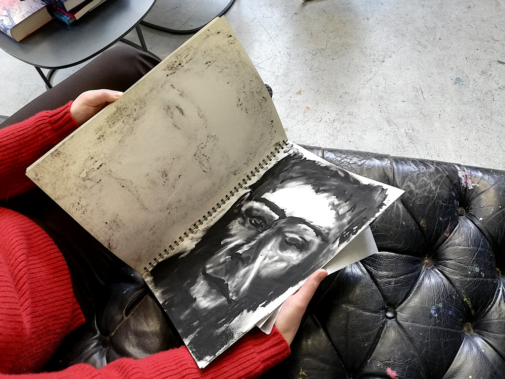 image Olympe-Racana-Weiler,-atelier,-cahier-de-dessins-à-la-craie-noire,-©Harry-Kampianne-LD